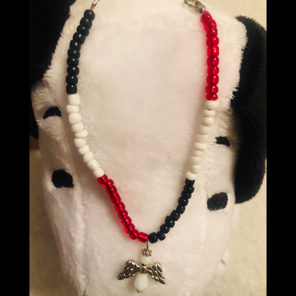 Red/White/Black beaded bracelet w/ an angel charm.